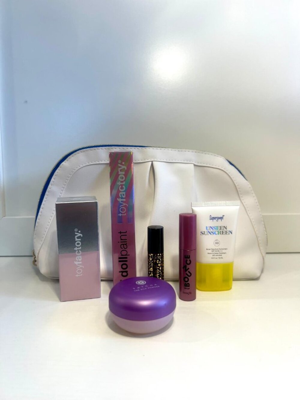 Cosmetic bag with makeup and skincare products (Full, Travel and Sample Sizes)